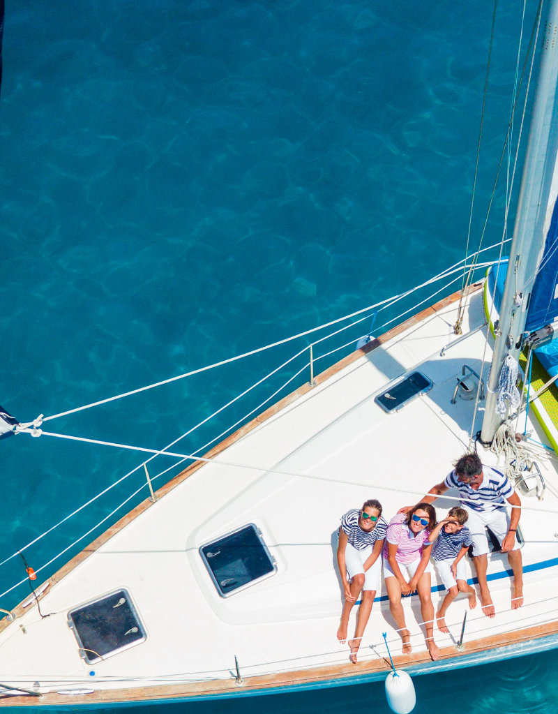 family on yacht in beautiful blue waters