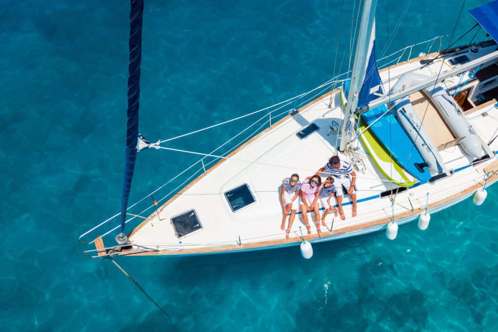 A happy family on a yacht in idyllic blue waters