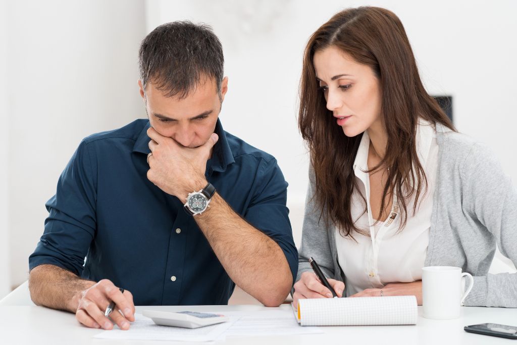 Husband and wife reviewing their finances together