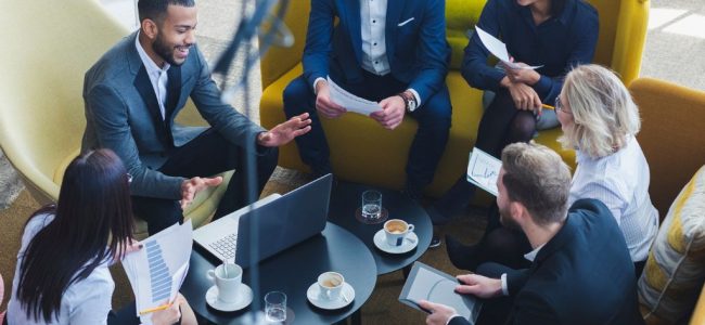 a group of dynamic male and female professionals in a collaborative meeting in a modern office
