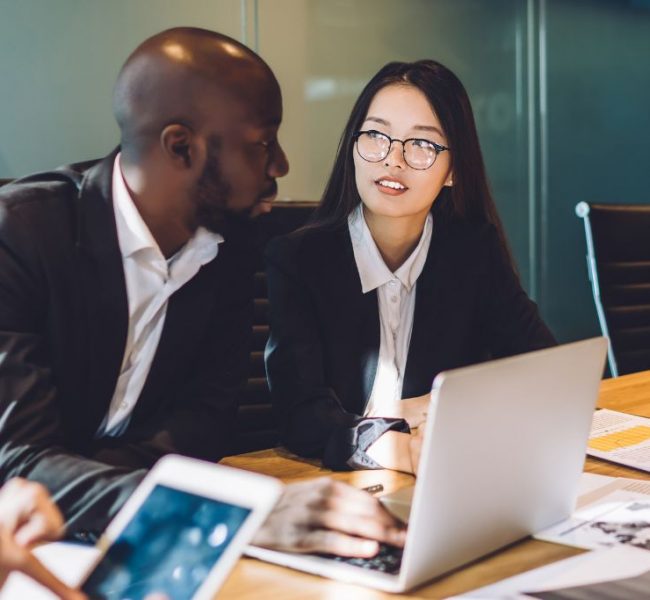 male and female professionals discussing collaborations in the office