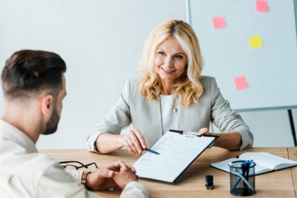 Mortgage professional woman helping a young man to arrange a mortgage with Aetas Partners