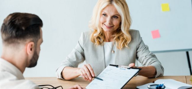 Aetas Partners business services Mortgage professional woman helping a young man to arrange a mortgage with Aetas Partners