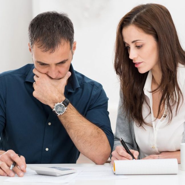 Husband and wife reviewing their finances together