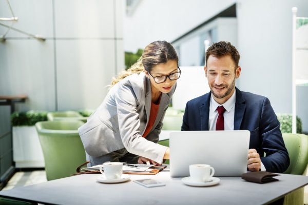 Male business owner and female support staff working in the office