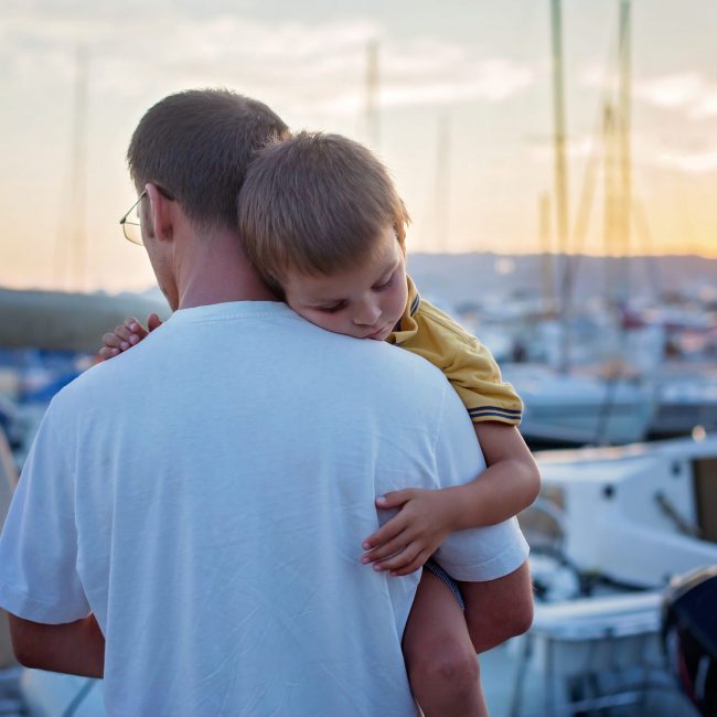 aetas-partners-financial-services-platform Father, holding his young sleeping child, while enjoying the sun
