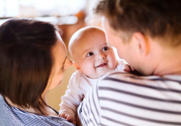 Happy,Parents,Holding,And,Playing,,Kissing,Small,Baby,,Carrying,Him